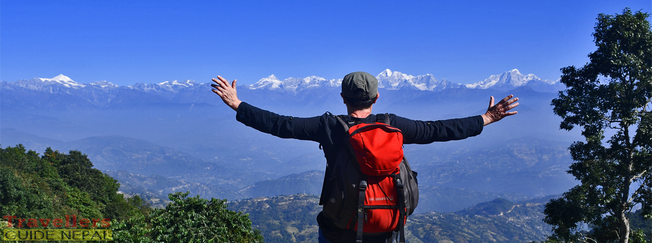 Panoramic view of snow-covered Himalayan peaks and forested valleys at sunrise